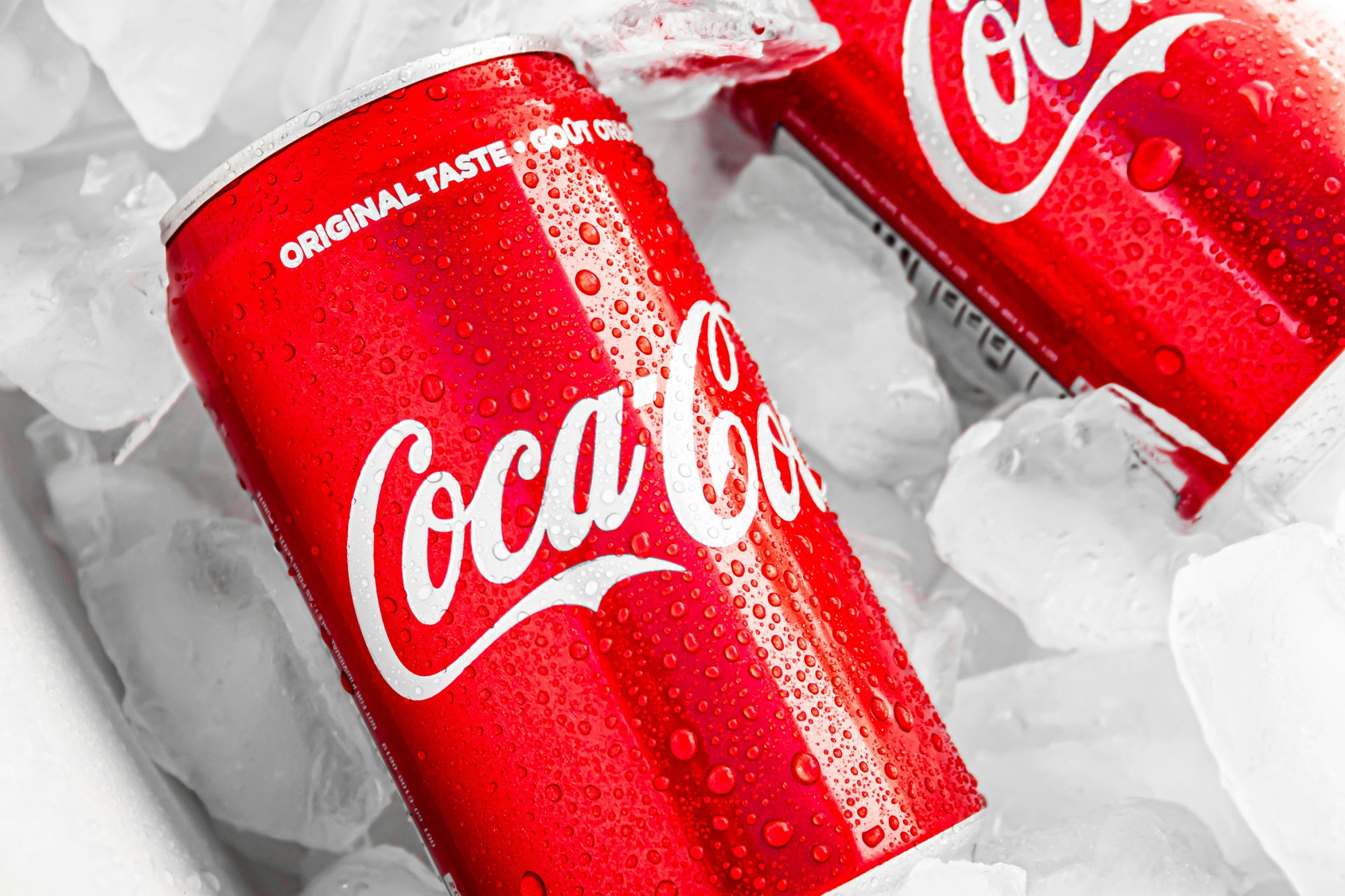 coca-cola-can-on-white-plastic-pack.jpg coca cola can on white plastic pack